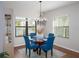 Dining room with modern chandelier and large windows overlooking the outdoor scenery at 209 Malina Ct, Nokomis, FL 34275