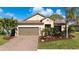 Charming single Gathering home featuring a beautiful terra cotta roof, a two car garage, and a manicured front lawn at 209 Malina Ct, Nokomis, FL 34275