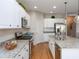Bright kitchen with stainless steel appliances, granite countertops, and white cabinetry at 209 Malina Ct, Nokomis, FL 34275