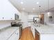Bright kitchen with stainless steel appliances, granite countertops, and white cabinetry at 209 Malina Ct, Nokomis, FL 34275