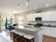 Open concept kitchen with island, granite countertops, stainless appliances, and adjacent dining area at 209 Malina Ct, Nokomis, FL 34275