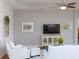 Bright living room with accent wall, modern furniture, and decorative artwork at 209 Malina Ct, Nokomis, FL 34275