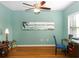 Bright office featuring wood floors, a ceiling fan, and a serene painting on the wall at 209 Malina Ct, Nokomis, FL 34275