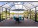 Covered brick patio with dining set and views of the lake at 209 Malina Ct, Nokomis, FL 34275