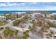 Stunning coastal community aerial view showcasing homes, lush palm trees, and the beautiful ocean in the distance at 2825 N Beach Rd, Englewood, FL 34223