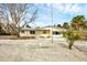 Welcoming single-story house with a tidy front yard, a bright facade, and some tropical accents at 2825 N Beach Rd, Englewood, FL 34223