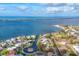 An aerial view of a waterfront community with canals leading to a bay and the ocean beyond at 295 North Dr, Englewood, FL 34223