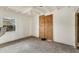 This bedroom features white walls and ceiling with boarded door space for renovation or custom design at 295 North Dr, Englewood, FL 34223