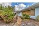 Charming single-story home with a stone walkway and beautiful flowering bushes at 295 North Dr, Englewood, FL 34223