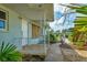 Front entrance featuring a stone walkway and cozy covered porch with decorative railing at 295 North Dr, Englewood, FL 34223