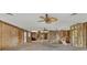 Open-concept living room featuring ceiling fans and unfinished walls, perfect for renovation and customization at 295 North Dr, Englewood, FL 34223