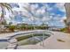 Backyard pool and spa overlook the waterfront and include lush tropical landscaping at 295 North Dr, Englewood, FL 34223