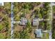 Aerial view of a property with a pool, surrounded by lush trees and a well-maintained neighborhood at 3892 Alwood St, North Port, FL 34291