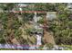 Expansive property with mature trees and a long driveway, offering privacy at 3892 Alwood St, North Port, FL 34291