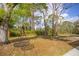 Backyard featuring a comfortable hanging swing, surrounded by lush greenery at 3892 Alwood St, North Port, FL 34291