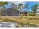 Home's backyard with lawn and screened in back porch at 3892 Alwood St, North Port, FL 34291