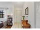 Bright entryway with tiled floors, decorative table, and view into the living room at 3892 Alwood St, North Port, FL 34291