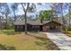 Charming single-story home with a brick facade and a well-maintained front lawn at 3892 Alwood St, North Port, FL 34291
