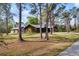 Exterior view of a house featuring a large lot with mature trees at 3892 Alwood St, North Port, FL 34291