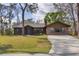 Well-maintained single-story home with a brick facade and a large front yard at 3892 Alwood St, North Port, FL 34291
