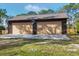 Large two-car garage with a basketball hoop, offering ample space for vehicles and storage at 3892 Alwood St, North Port, FL 34291