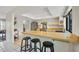 Bright kitchen featuring a light wood breakfast bar, stainless steel appliances and a skylight at 3892 Alwood St, North Port, FL 34291
