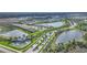 Beautiful aerial view of the community with ponds, lush greenery, and a grand entrance at 6237 Fish Eagle Ct, Nokomis, FL 34275