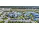 An aerial view displaying a vibrant community with a pool, tennis courts, and well-manicured landscaping at 6237 Fish Eagle Ct, Nokomis, FL 34275