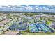Picturesque aerial view highlighting the community with tennis courts, pool, clubhouse, and surrounding landscapes at 6237 Fish Eagle Ct, Nokomis, FL 34275