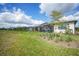 Spacious backyard featuring a large green area and views of neighboring properties and inviting screened-in patio at 6237 Fish Eagle Ct, Nokomis, FL 34275