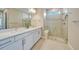 Modern bathroom with double vanity sinks, a walk-in shower with glass door at 6237 Fish Eagle Ct, Nokomis, FL 34275