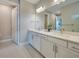 Bathroom featuring double sinks, large mirror and a neutral color scheme at 6237 Fish Eagle Ct, Nokomis, FL 34275