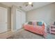 Inviting bedroom showcases a daybed with colorful pillows, sliding closet doors, and soft lighting, perfect for relaxation at 6237 Fish Eagle Ct, Nokomis, FL 34275