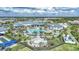 Overhead shot of a luxurious community pool area with palm trees, lounge chairs, and meticulously maintained gardens; perfect for relaxation at 6237 Fish Eagle Ct, Nokomis, FL 34275