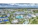 Aerial view of a stunning community pool and clubhouse surrounded by lush landscaping and beautiful homes in a vibrant neighborhood at 6237 Fish Eagle Ct, Nokomis, FL 34275