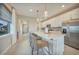 Kitchen island with a breakfast bar, stainless steel appliances, and pendant lighting at 6237 Fish Eagle Ct, Nokomis, FL 34275