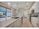 Bright kitchen with white cabinets, stainless steel appliances and island with seating at 6237 Fish Eagle Ct, Nokomis, FL 34275