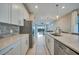 Bright kitchen with white cabinets, stainless steel appliances, and a long quartz countertop at 6237 Fish Eagle Ct, Nokomis, FL 34275