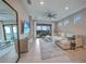 Spacious living room featuring tile floors, a ceiling fan, and sliding glass doors at 6237 Fish Eagle Ct, Nokomis, FL 34275