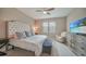 Comfortable bedroom featuring a soft armchair, large dresser and neutral décor at 6237 Fish Eagle Ct, Nokomis, FL 34275