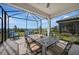 Charming screened patio with comfortable seating, a dining table, and serene backyard views, creating a perfect retreat at 6237 Fish Eagle Ct, Nokomis, FL 34275