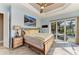 Bedroom featuring light blue walls, wood floors, and sliding glass doors to the pool at 8200 Antwerp Cir, Port Charlotte, FL 33981