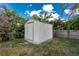 Backyard shed provides extra storage space with mature foliage nearby at 1003 Old Englewood Rd, Englewood, FL 34223