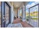 Cozy screened-in entryway with brick flooring and a seating area at 107 Abercrombie Ave, Englewood, FL 34223