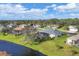 Beautiful exterior view of a lovely home, screened in pool, lush lawn and trees in a desirable neighborhood at 107 Abercrombie Ave, Englewood, FL 34223