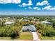 Aerial view of a single-story home surrounded by trees in a residential neighborhood at 11453 Oceanspray Blvd, Englewood, FL 34224