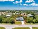 An aerial shot showcases a single-story home nestled amongst lush greenery at 11453 Oceanspray Blvd, Englewood, FL 34224