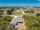 An aerial view of a well-maintained single-Gathering home featuring a screened lanai in a lush, green neighborhood at 11453 Oceanspray Blvd, Englewood, FL 34224