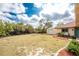 Large backyard with a storage shed, patio, and tropical plants at 11453 Oceanspray Blvd, Englewood, FL 34224