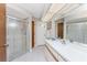 Bathroom featuring tiled floors, neutral paint, and a large sink, with a walk-in shower with glass doors at 11453 Oceanspray Blvd, Englewood, FL 34224